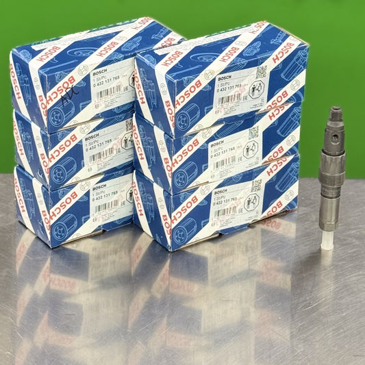 Bosch spark plug boxes on a reflective surface with a green background