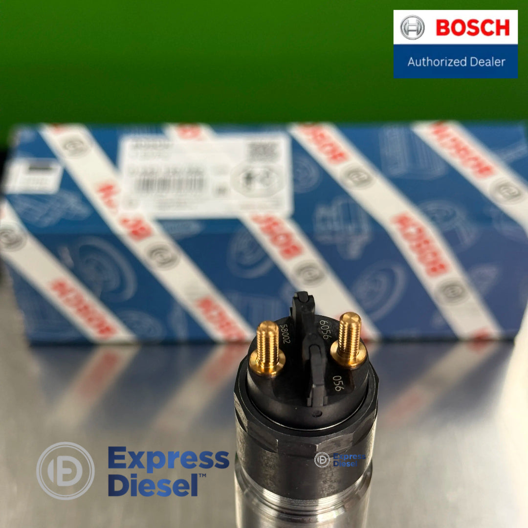 close up of genuine bosch 0445120056 common rail injector upper connection and original bosch packaging