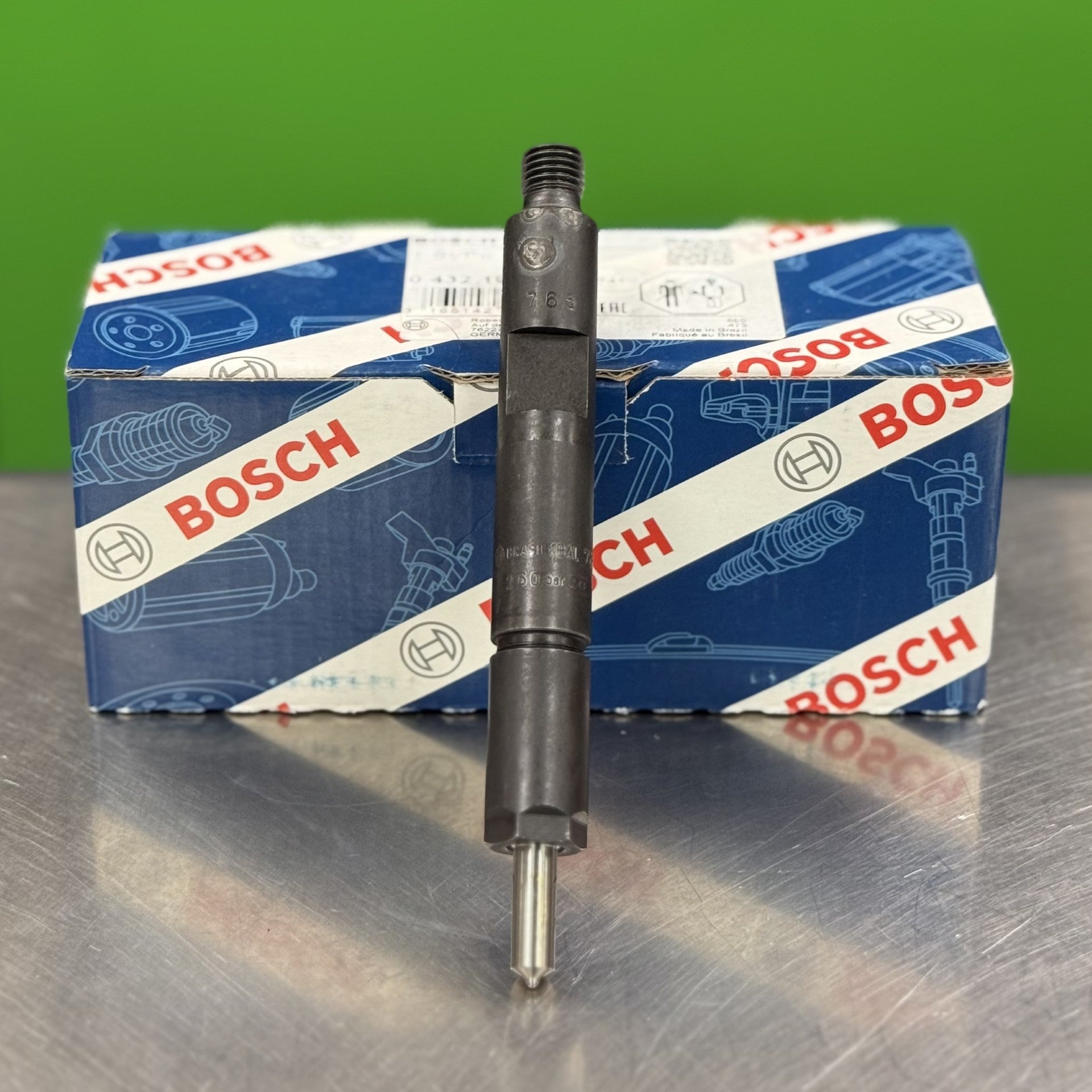 Bosch automotive part on a metallic surface with a green background