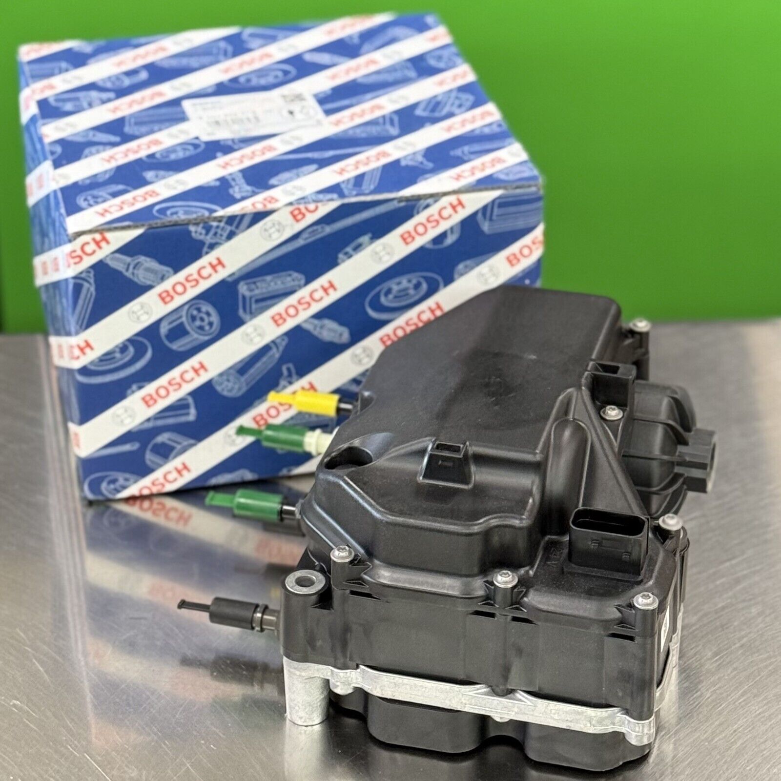 Close-up of Bosch DEF doser pump module 044404227G showing precision housing and fittings