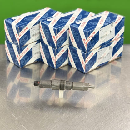 Multiple boxes of Bosch spark plugs on a reflective surface with a green background